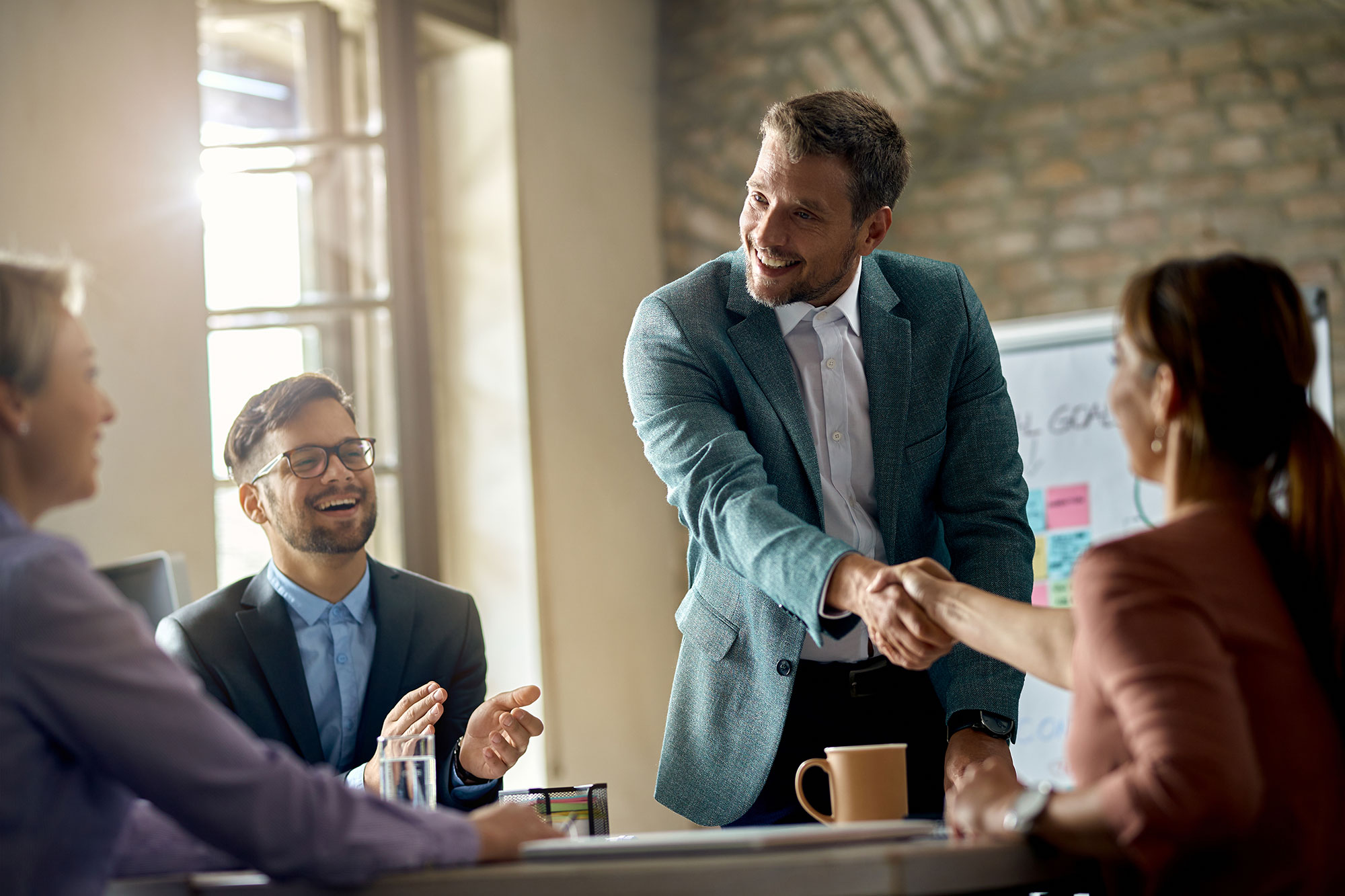 happy-businessmen-greeting-his-colleagues-meeting-shaking-hands